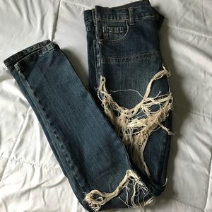 Woman's cheap Monday distressed skinny jeans.